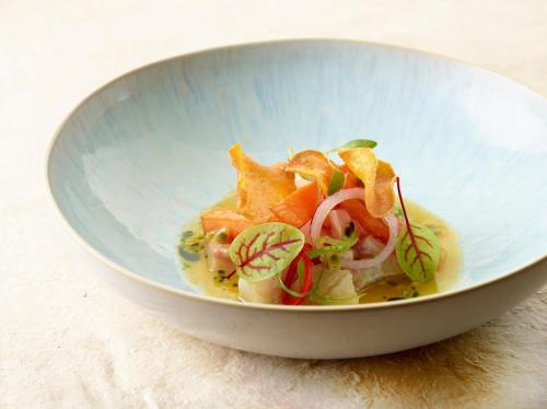 a blue bowl of food with vegetables in it at Hotel Sanglier in Durbuy