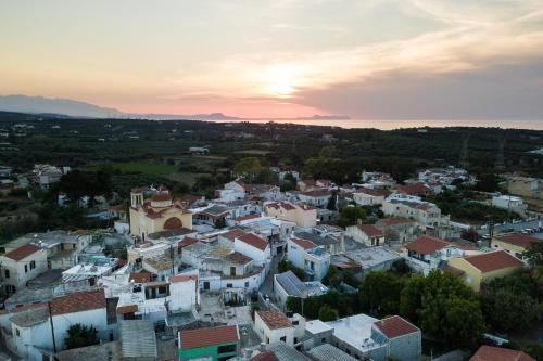an aerial view of a town at sunset at Muazzo Creta Stone House, Nature Escape with Pool, By ThinkVilla in Pigi