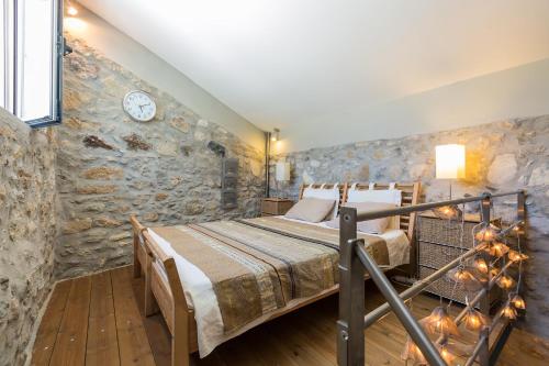 Un pat sau paturi într-o cameră la Muazzo Creta Stone House, a Fairytale Cottage, By ThinkVilla