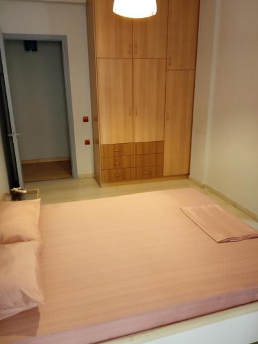 a room with a bed and a cabinet at Karditsa Home Sweet Home 80 τ.μ in Kardítsa
