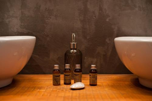 three bottles of essential oils sitting next to two toilets at Ktima Fabiatos in Skala Kefalonias