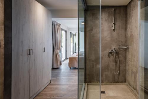 a bathroom with a shower and a glass door at Ktima Fabiatos in Skala Kefalonias