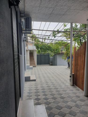 an empty courtyard with a fence and a building at Comfort in Tbilisi City