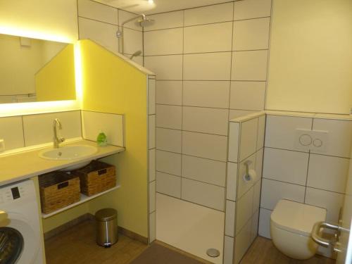 a small bathroom with a toilet and a sink at Ferienwohnung Paula in Lichtenstein