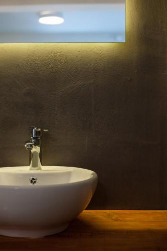 a white sink in a bathroom with a blue light at Ktima Fabiatos in Skala Kefalonias