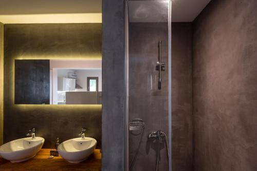 a bathroom with two sinks and a glass shower at Ktima Fabiatos in Skala Kefalonias