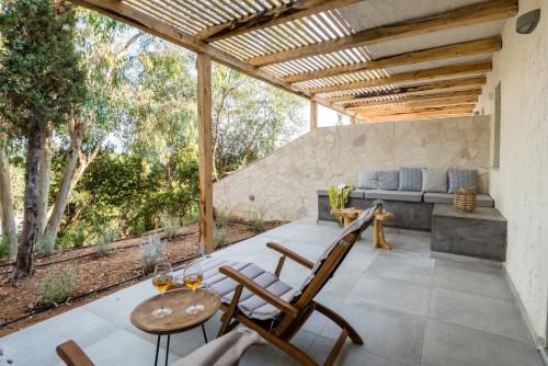 a patio with a couch and chairs and a table at Ktima Fabiatos in Skala Kefalonias
