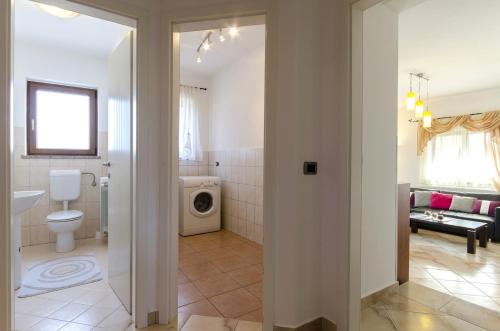 a bathroom with a sink and a toilet in a room at Villa Rose in Rovinj