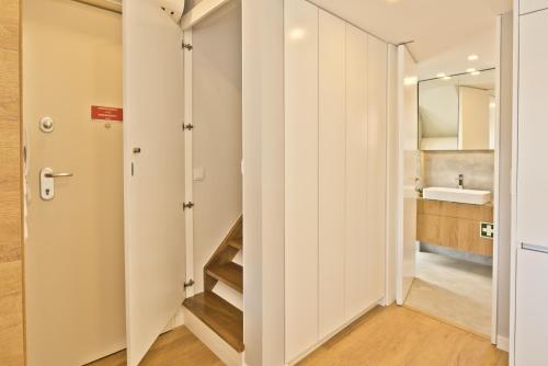 a bathroom with white cabinets and a sink at BmyGuest Bruno’s 36 Apartments in Lisbon