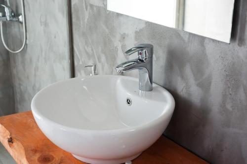 a white sink in a bathroom with a mirror at Ktima Fabiatos in Skala Kefalonias