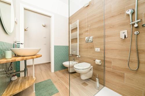 a bathroom with a toilet and a sink and a shower at Santaló B&B in Bitonto