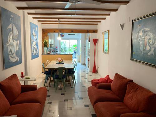 a living room with a couch and a table at Denia Townhouse in Denia