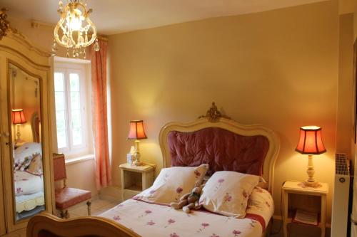 a bedroom with a bed and a large mirror at Au Coeur de Rennes Chambres d'hôtes in Rennes-les-Bains