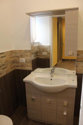 a bathroom with a sink and a mirror at Naxos Laguna Beach in Giardini Naxos