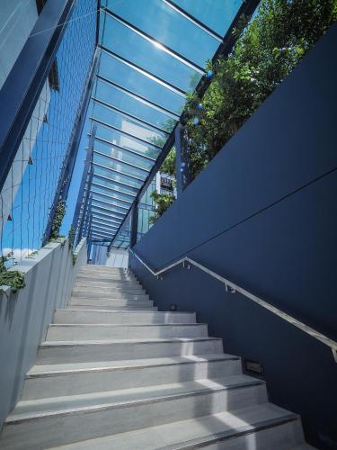 a staircase leading up to a building with a glass ceiling at Tassana Place in Chon Buri