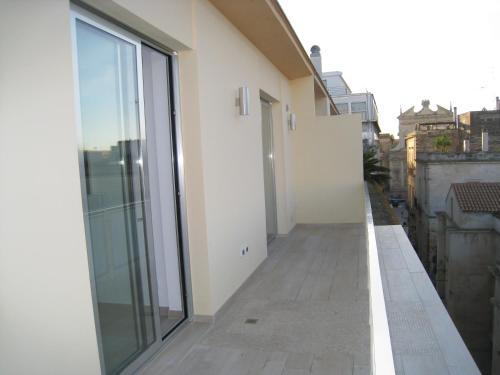 a balcony with sliding glass doors on a building at Penthouse Santa Croce in Lecce