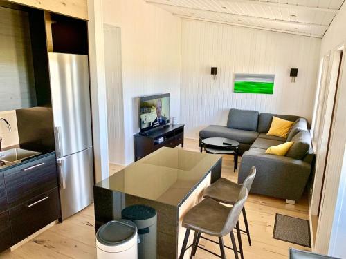 a kitchen and a living room with a couch at Lundur in Borgarnes