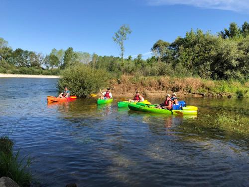 a group of people in kayaks on a river at Camping Le Canoë in Chaussin