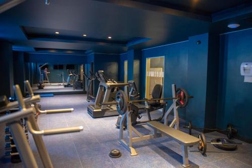 a gym with several tread machines in a blue room at Hotel Termas Chillán in Nevados de Chillan