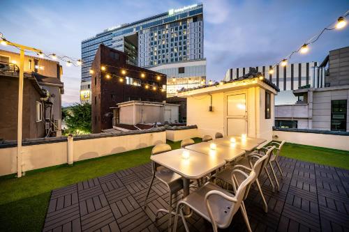 a patio with a table and chairs on a rooftop at YAB-GuestHouse, FemaleOnly, ForeignOnly in Seoul