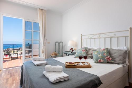 a bedroom with a bed with a view of the ocean at VILLA ATLANTIC view with JACUZZI in Adeje