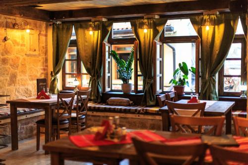 a restaurant with tables and chairs and windows at Villa Irma in Bar