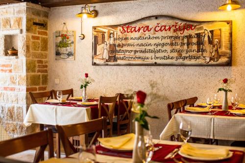 a restaurant with tables and chairs and a sign on the wall at Villa Irma in Bar