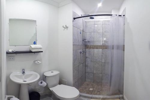 a bathroom with a shower and a toilet and a sink at Hotel Las Lunas in San Andrés