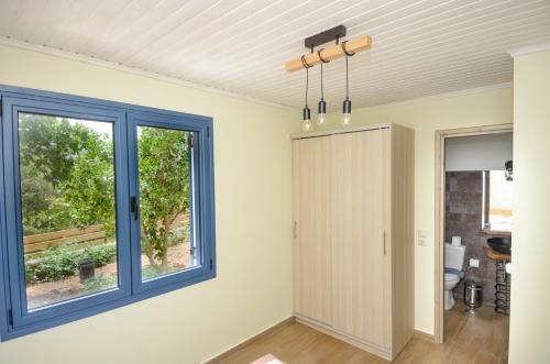a room with a door and a window at Kokonis House in Ayia Evfimia