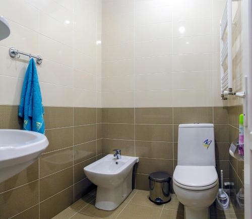 a bathroom with a toilet and a sink at Apartment Amaghleba in Tbilisi City
