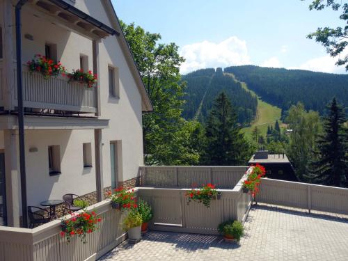 a balcony of a building with flowers on it at Pension Valon in Špindlerův Mlýn