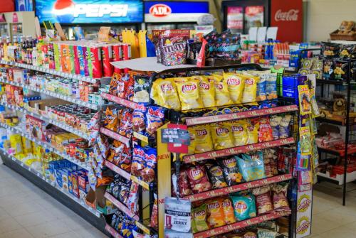 a store aisle with a display of food and snacks at Winds Motel in Montague