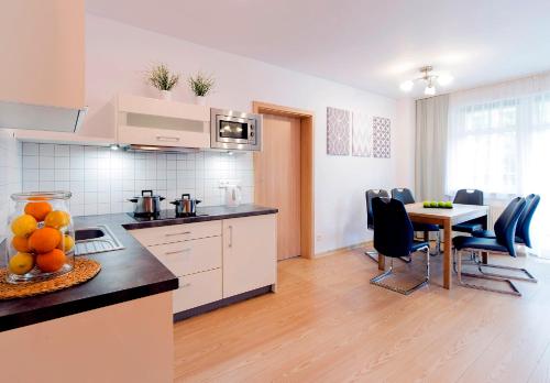 a kitchen and dining room with a table and chairs at Malina Apartamenty in Szklarska Poręba