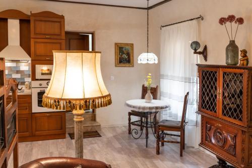 a living room with a table and a lamp at Historic Apartment in the heart of the City in Veliko Tŭrnovo