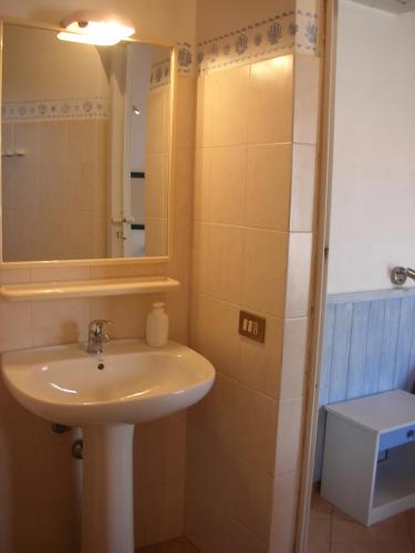 a bathroom with a sink and a mirror and a shower at B&B Caserta in Ustica