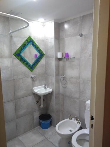 a bathroom with a toilet and a sink at Hostería Altea in Monte Hermoso