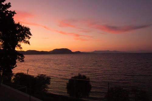 a sunset over a large body of water at Casa del Mar in Mpoukaris