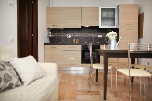 a kitchen with a table and a dining room at Agriturismo Il Vecchio Mandorlo in Perugia