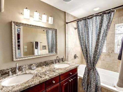 a bathroom with two sinks and a tub and a mirror at Kierland Villa · North Scottsdale Home w/Pool~Walk to Kierland Area in Scottsdale