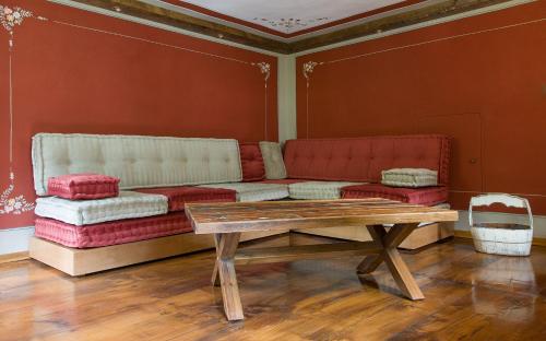 a living room with a couch and a table at Ca’d’ambra in Groscavallo