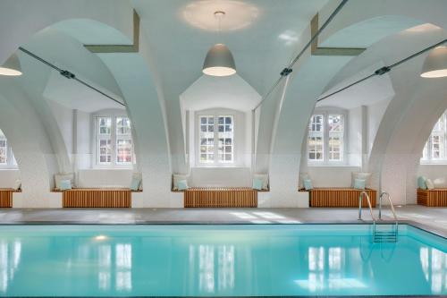 a large swimming pool with a large mirror at Chateau Herálec Boutique Hotel & Spa by L'Occitane in Herálec