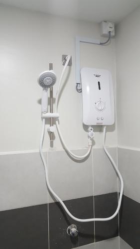 a shower in a bathroom with a hair dryer at TINGKAT 21/10, PANGSAPURI LADANG TOK PELAM in Kuala Terengganu