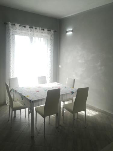a dining room with a table with chairs and a window at Affittacamere New Lifestyle in Alberoro