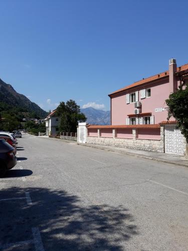 an empty street with cars parked on the side of a building at Maritimo Apartments in Kotor