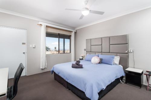 a bedroom with a large bed with a teddy bear on it at Archibald Hotel in Kurrajong