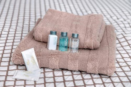 a towel with three bottles ofodorizers on it at Apartment on Fastovskaya 29 in Vladivostok