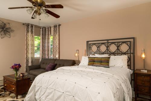 a bedroom with a bed and a ceiling fan at Rosemont Inn in Utica