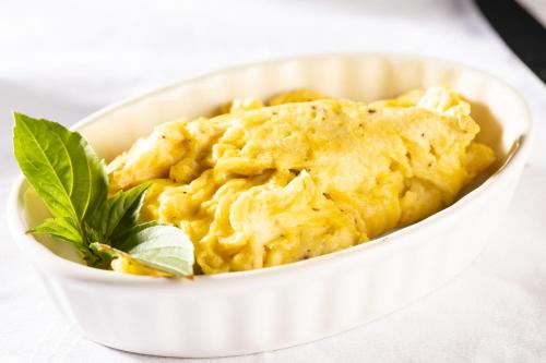 a bowl of macaroni and cheese with a green garnishment at Rosemont Inn in Utica