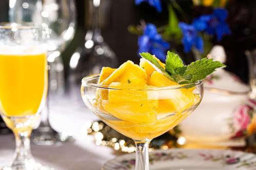 a glass bowl of orange juice and a drink at Rosemont Inn in Utica