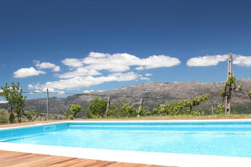 a swimming pool with a mountain in the background at Casa Da Gaiteira in Vieira do Minho